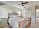 Bright bedroom with a light color palette, ceiling fan, and a plush bed at 2000 Variations Dr, Atlanta, GA 30329