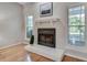 Living room fireplace with white mantel and hardwood floors, bathed in natural light at 2000 Variations Dr, Atlanta, GA 30329