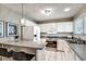 Updated kitchen featuring white cabinetry, stainless steel appliances, and a breakfast bar at 2000 Variations Dr, Atlanta, GA 30329