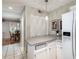 Bright kitchen with white cabinets, stone countertops, and dining area visible in the background at 2000 Variations Dr, Atlanta, GA 30329