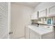 Functional laundry room with washer, dryer, and overhead cabinet storage space at 2000 Variations Dr, Atlanta, GA 30329