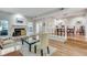 Spacious living room with fireplace flowing to dining area, featuring hardwood floors and natural light at 2000 Variations Dr, Atlanta, GA 30329