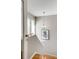 A naturally lit staircase with stylish light fixture and neutral paint at 2000 Variations Dr, Atlanta, GA 30329