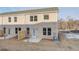 Back of home features a small patio and a grassy area with young trees at 224 Sanctuary Dr, Mcdonough, GA 30253