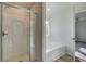 Bathroom features walk-in glass shower and soaking tub with window at 224 Sanctuary Dr, Mcdonough, GA 30253