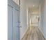 A bright hallway with modern vinyl flooring and neutral paint leads into this home at 224 Sanctuary Dr, Mcdonough, GA 30253