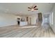 Open-concept living room with a fan, a staircase and modern vinyl flooring at 224 Sanctuary Dr, Mcdonough, GA 30253