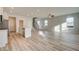 Open-concept living room and kitchen with vinyl floors and modern fixtures at 224 Sanctuary Dr, Mcdonough, GA 30253