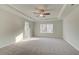 Large main bedroom with tray ceiling, ceiling fan, and carpet at 224 Sanctuary Dr, Mcdonough, GA 30253