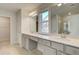 Bathroom with double vanity, walk in shower, ample storage, and view to exterior at 117 Belvedere Rd, Mcdonough, GA 30253