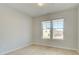 Bright bedroom featuring two windows and light colored, wood-look floors at 117 Belvedere Rd, Mcdonough, GA 30253
