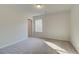 Well lit bedroom features light carpet, neutral walls, and a large window that provides natural light at 117 Belvedere Rd, Mcdonough, GA 30253