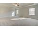 Expansive primary bedroom boasts plush carpeting, tray ceilings, and ample natural light at 117 Belvedere Rd, Mcdonough, GA 30253