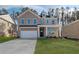 Charming two-story brick home featuring a two-car garage and well-manicured lawn at 117 Belvedere Rd, Mcdonough, GA 30253