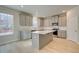 Modern kitchen features gray cabinets, stainless appliances, and a center island with white countertop at 117 Belvedere Rd, Mcdonough, GA 30253