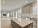 Spacious open layout features kitchen island with view of living room with fireplace and multiple windows at 117 Belvedere Rd, Mcdonough, GA 30253