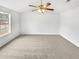 Brightly lit bedroom with a large window, neutral decor, and a ceiling fan at 4969 Portsmouth Ct, Lithonia, GA 30038