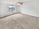 Brightly lit bedroom with a large window, neutral decor, and a ceiling fan at 4969 Portsmouth Ct, Lithonia, GA 30038