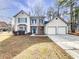 Charming two-story home with a two car garage and front-facing balcony, perfect for enjoying the outdoors at 4969 Portsmouth Ct, Lithonia, GA 30038