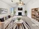 Bright living room with a fireplace, ceiling fan, and neutral decor, creating a warm and inviting atmosphere at 4969 Portsmouth Ct, Lithonia, GA 30038