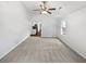 Bright living room features neutral carpet, a ceiling fan, and a window for natural light at 4969 Portsmouth Ct, Lithonia, GA 30038
