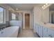 Bathroom featuring a tub, shower, and double sink vanity with white cabinets at 112 Felicity Pike, Locust Grove, GA 30248
