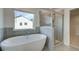 Bathroom with soaking tub, glass-enclosed shower, and window for natural light at 112 Felicity Pike, Locust Grove, GA 30248