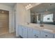 Bathroom featuring a double sink vanity with white cabinets and a tile floor at 112 Felicity Pike, Locust Grove, GA 30248