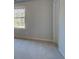 This bedroom features neutral walls, carpet flooring, and a window at 112 Felicity Pike, Locust Grove, GA 30248