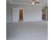 Spacious bedroom with carpet, ceiling fan, and access to other rooms at 112 Felicity Pike, Locust Grove, GA 30248