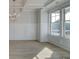 Bright dining room with a coffered ceiling, wainscoting, light wood floors, and large windows at 112 Felicity Pike, Locust Grove, GA 30248