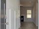 Welcoming foyer with wainscoting, wood-look flooring, and views of the living room with a fireplace at 112 Felicity Pike, Locust Grove, GA 30248