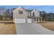 Charming new two-story home featuring a three-car garage, gray brick and siding, and a well-manicured lawn at 112 Felicity Pike, Locust Grove, GA 30248
