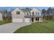 Charming new two-story home featuring a three-car garage, gray brick and siding, and a well-manicured lawn at 112 Felicity Pike, Locust Grove, GA 30248