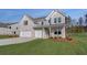 Charming new two-story home featuring a three-car garage, gray brick and siding, and a well-manicured lawn at 112 Felicity Pike, Locust Grove, GA 30248
