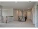 Upstairs hallway with neutral paint, carpet, and black iron railing at 112 Felicity Pike, Locust Grove, GA 30248