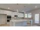 Stylish kitchen features a large island, stainless appliances, pendant lighting and modern cabinetry at 112 Felicity Pike, Locust Grove, GA 30248