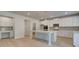 Bright kitchen with white cabinets, large island, stainless steel appliances, and desk area at 112 Felicity Pike, Locust Grove, GA 30248