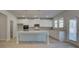 Modern kitchen with white cabinets, large island, stainless appliances, and breakfast area at 112 Felicity Pike, Locust Grove, GA 30248