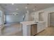 Open kitchen showcases a center island, stainless dishwasher and an adjacent living room at 112 Felicity Pike, Locust Grove, GA 30248