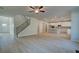 Open-concept space with a staircase, a modern kitchen, light wood floors, and lots of natural light at 112 Felicity Pike, Locust Grove, GA 30248