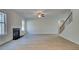 Spacious living room features wood floors and modern fireplace, leading to staircase at 112 Felicity Pike, Locust Grove, GA 30248
