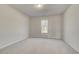 Bright carpeted bedroom features a neutral color palette and natural light through a single window at 120 Felicity Pike, Locust Grove, GA 30248