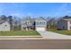 Charming two-story home featuring a brick and siding exterior, a well-manicured lawn, and a two-car garage at 120 Felicity Pike, Locust Grove, GA 30248