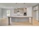 Modern kitchen features a large central island, stainless steel appliances, and modern pendant lighting at 120 Felicity Pike, Locust Grove, GA 30248