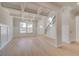 Inviting living room showcasing coffered ceilings, hardwood floors, and large windows for ample natural light at 120 Felicity Pike, Locust Grove, GA 30248