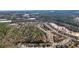 Birds-eye view showing the neighborhood layout adjacent to a natural wooded area at 620 Willow Haven Way, Suwanee, GA 30024