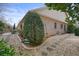 Landscaped backyard with a winding stone path, mature trees, and outdoor living space at 620 Willow Haven Way, Suwanee, GA 30024