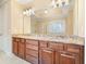 Bathroom vanity with granite countertop, undermount sinks, and large mirror at 620 Willow Haven Way, Suwanee, GA 30024