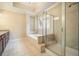 Modern bathroom featuring a glass-enclosed shower and a separate soaking tub at 620 Willow Haven Way, Suwanee, GA 30024